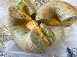 The "spinach" bagel with egg, cheese, and avocado.